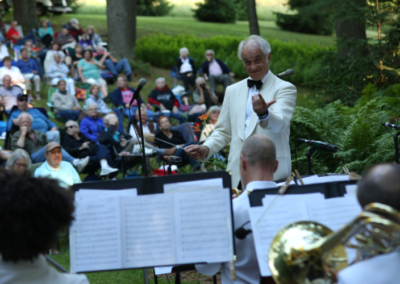 A music conductor directs his band at the wildflower music festival